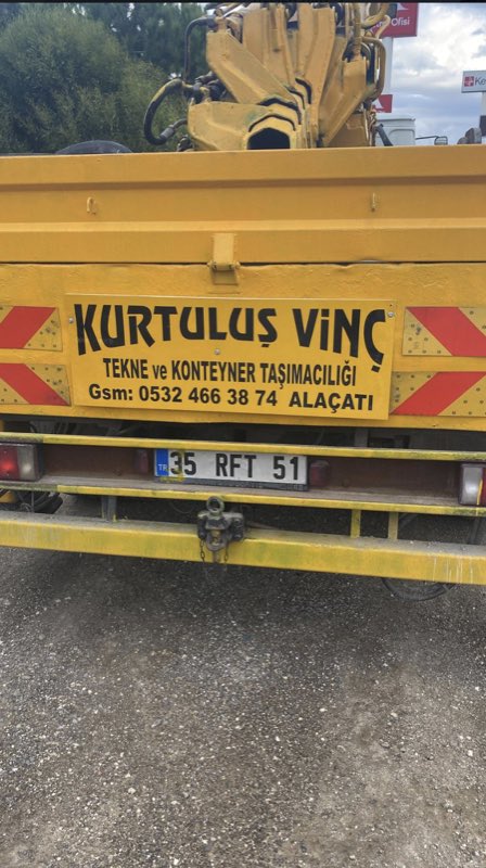 Kurtuluş Vinç aracının üzerindeki firma bilgileri: tekne ve konteyner taşımacılığı, Alaçatı